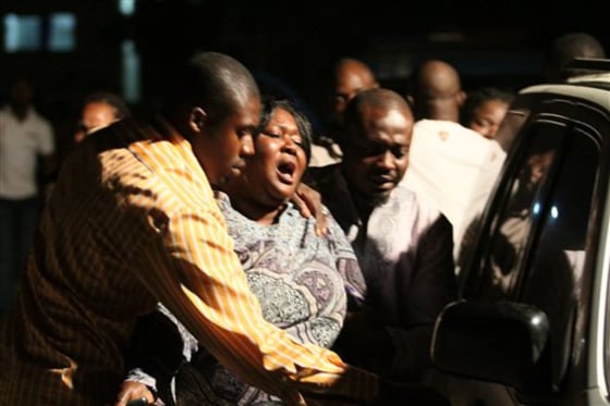 A woman who lost a relative in a bomb explosion, center, mourns at the Asokoro General Hospital, Abuja, Nigeria, on Friday. A bomb blast tore through a beer garden at a Nigerian army barracks where revelers had gathered to celebrate New Year's Eve, witnesses said. 